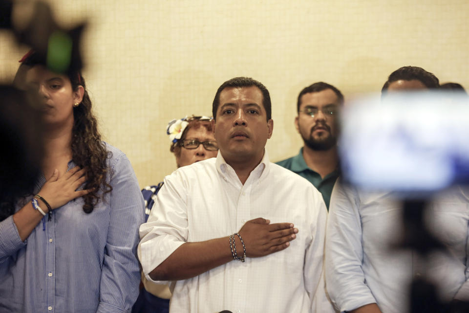 FILE - In this Sept. 18, 2019 file photo, Nicaraguan opposition activist Felix Maradiaga, center, stands at attention as the national anthem is sung during a press conference in Managua, Nicaragua. Nicaragua’s National Police has on Tuesday, June 8, 2021, arrested Maradiaga, a potential challenger to President Daniel Ortega, the third opposition pre-candidate for the Nov. 7 elections detained in the past week. (AP Photo/Alfredo Zuniga, File)