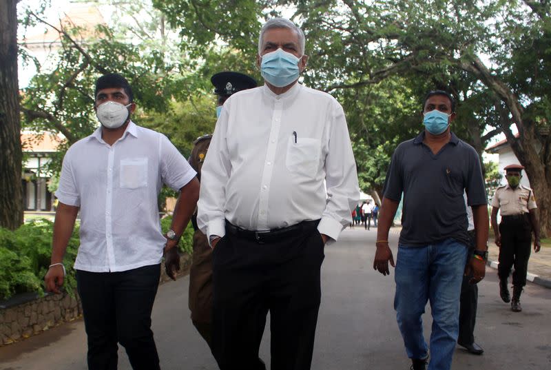 Wickremesinghe wearing a protective mask leaves after casting his vote at a polling station during the country's parliamentary election in Colombo