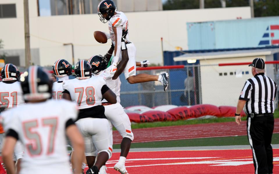 Lakeland receiver Omari Mixon celebrates in the end zone with teammates after catching a 20-yard touchdown pass in the first quarter against Clearwater on Friday at Jack White Stadium.