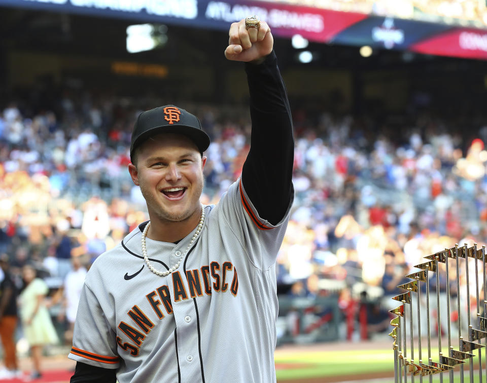 Former Atlanta Braves outfielder Joc Pederson is presented his World Series ring and shows it off proudly to Braves fans before the San Francisco Giants play the Braves in a baseball game on Monday, June 20, 2022, in Atlanta. (Curtis Compton/Atlanta Journal-Constitution via AP)