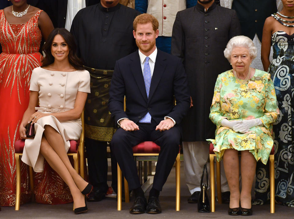 LONDON, ENGLAND - JUNE 26: Meghan, Duchess of Sussex, Prince Harry, Duke of Sussex and Queen Elizabeth II at the Queen's Young Leaders Awards Ceremony at Buckingham Palace on June 26, 2018 in London, England. The Queen's Young Leaders Programme, now in its fourth and final year, celebrates the achievements of young people from across the Commonwealth working to improve the lives of people across a diverse range of issues including supporting people living with mental health problems, access to education, promoting gender equality, food scarcity and climate change.  (Photo by John Stillwell - WPA Pool/Getty Images)