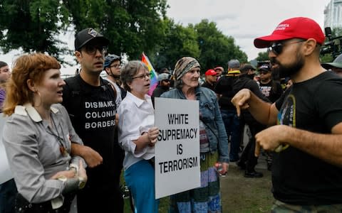 Counter-demonstrators (L) confront alt-right groups during "The End Domestic Terrorism" rally  - Credit: AP