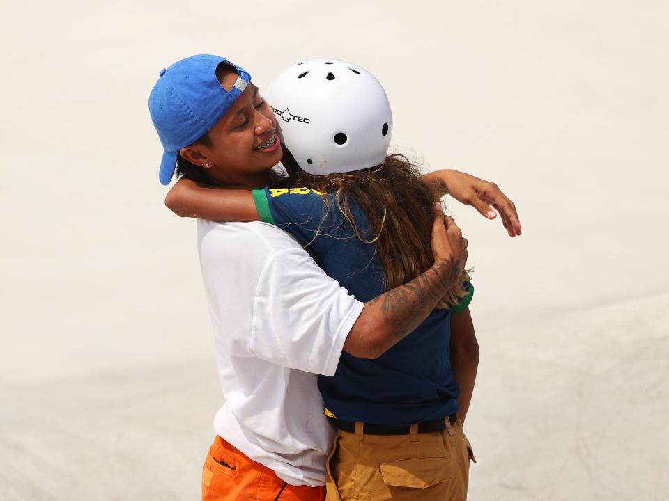 Margielyn Didal of Team Philippines hugs Rayssa Leal of Team Brazil during street skateboarding at the Tokyo Olympics.