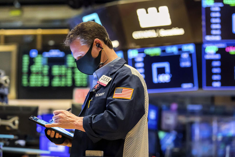 In this photo provided by the New York Stock Exchange, trader Robert Charmak works on the floor, Monday, March 1, 2021. Stocks are rising across the board on Wall Street as traders welcomed a move lower in long-term interest rates in the bond market. Investors were also watching Washington as a big economic stimulus bill moved to the Senate. (Courtney Crow/New York Stock Exchange via AP)