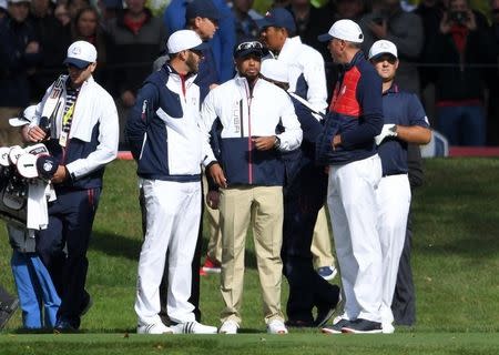Sep 28, 2016; Chaska, MN, USA; From left Dustin Johnson, Team USA vice-captain Tiger Woods and Matt Kuchar stand on the 13th green during the practice round for the Ryder Cup at Hazeltine National Golf Club. Mandatory Credit: Michael Madrid-USA TODAY Sports