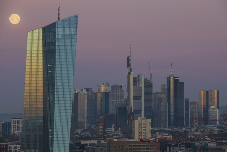 FRANKFURT AM MAIN, GERMANY - MARCH 21: Office buildings, including the corporate headquarters of the European Central Bank (ECB), Commerzbank and Deutsche Bank stand in the financial district in the city center lit by the full moon and the sunrise on March 21, 2019 in Frankfurt, Germany. Some finance-related companies have been moving offices from London to Frankfurt due to uncertainties over Brexit. (Photo by Thomas Lohnes/Getty Images) ORG XMIT: 775312841 ORIG FILE ID: 1137298442