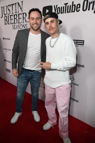 <p>Kevin Mazur/Getty</p> Scooter Braun and Justin Bieber in January 2020 in Westwood