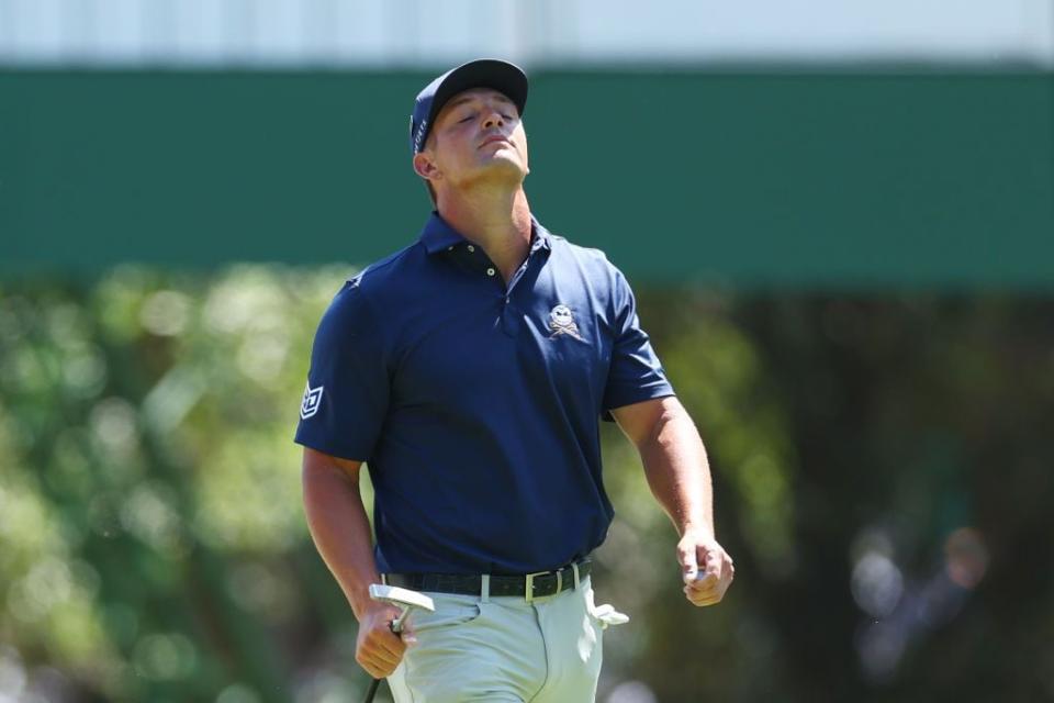 Bryson DeChambeau reacts after making bogey on the third hole.