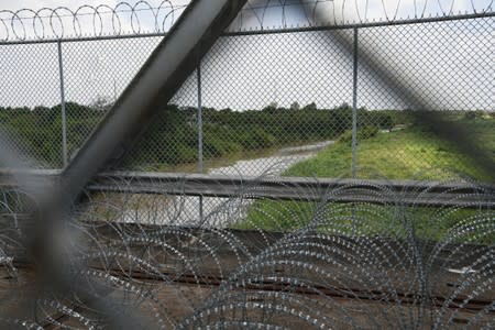 Barbed razor wire above the Rio Grande is pictured from the Mexican side of the Brownsville-Matamoros International Bridge