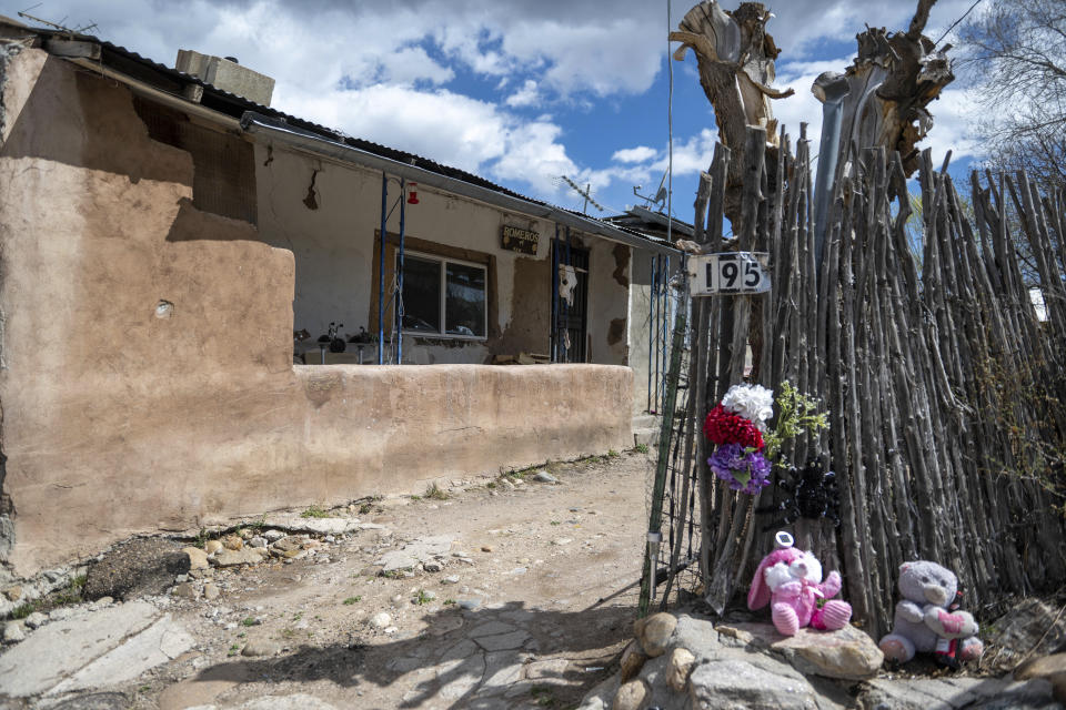 Stuffed animals and flowers adorn a street corner in Cordova, New Mexico, Friday, April 14, 2023. Ever since missionaries started building churches out of mud 400 years ago in what was the isolated frontier of the Spanish empire, tiny mountain communities like Cordova relied on their own resources to keep the faith going. (AP Photo/Roberto E. Rosales)