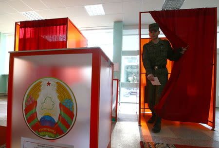 A Belarussian serviceman leaves a voting booth at a polling station during a parliamentary election, in Minsk, Belarus September 11, 2016. REUTERS/Vasily Fedosenko
