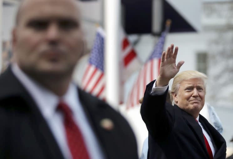 President Trump waves during the Inaugural Parade in Washington. (Photo: Carlos Barria/Reuters)