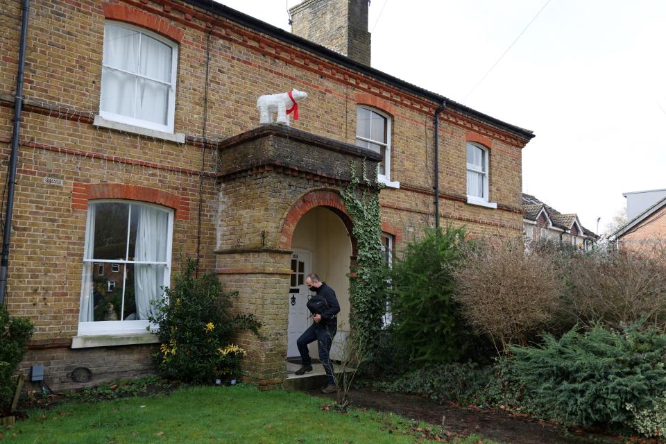 A member of the local council distributes coronavirus testing kits to residents in the Goldsworth Park and St John's suburbs or Woking, southwest of London, on February 2, 2021 as testing for the South African variant of Covid-19 is increased. - Health officials said Monday they will urgently increase testing in eight areas across England where nearly a dozen South African Covid-19 variant cases have been identified in the last week. (Photo by Adrian DENNIS / AFP) (Photo by ADRIAN DENNIS/AFP via Getty Images)