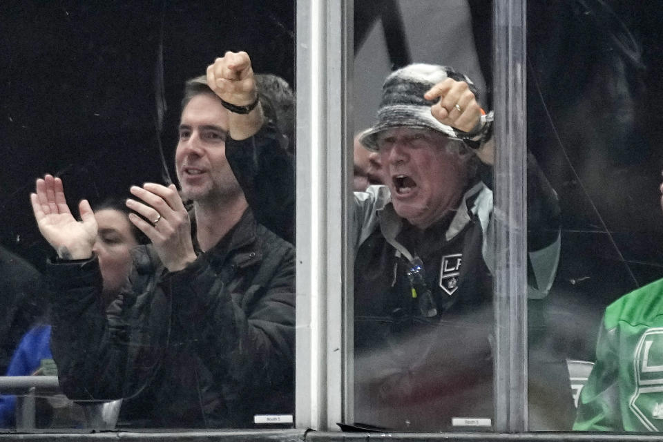Actor Will Ferrell, right, cheers during the second period of an NHL hockey game between the Los Angeles Kings and the San Jose Sharks Wednesday, Jan. 11, 2023, in Los Angeles. (AP Photo/Mark J. Terrill)