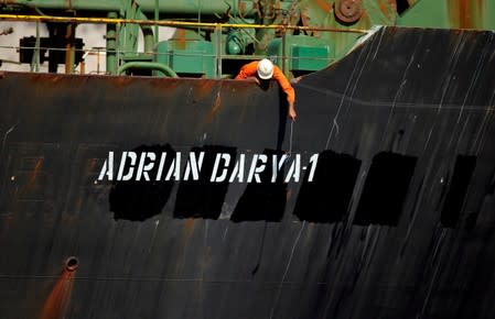 A crew member takes pictures with a mobile phone on Iranian oil tanker Adrian Darya 1, previously named Grace 1, sits anchored after the Supreme Court of the British territory lifted its detention order, in the Strait of Gibraltar