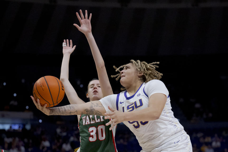 LSU guard Kateri Poole, right, shoots against Mississippi Valley State center Lucia Lara (30) during the second half of an NCAA college basketball game Sunday, Nov. 12, 2023, in Baton Rouge, La. (AP Photo/Matthew Hinton)