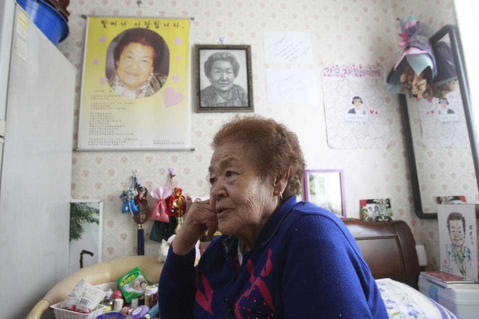 In this Feb. 3. 2014, Kim Gun-ja, 89, former comfort woman who was forced to serve for the Japanese troops as a sexual slave during World War II, speaks during an interview at the House of Sharing, a nursing home and museum for 10 former sex slaves, in Toechon, South Korea. There are only 55 women left who registered with the South Korean government as former sex slaves from the war _ down from a peak of more than 230. Their average age is 88. (AP Photo/Ahn Young-joon)