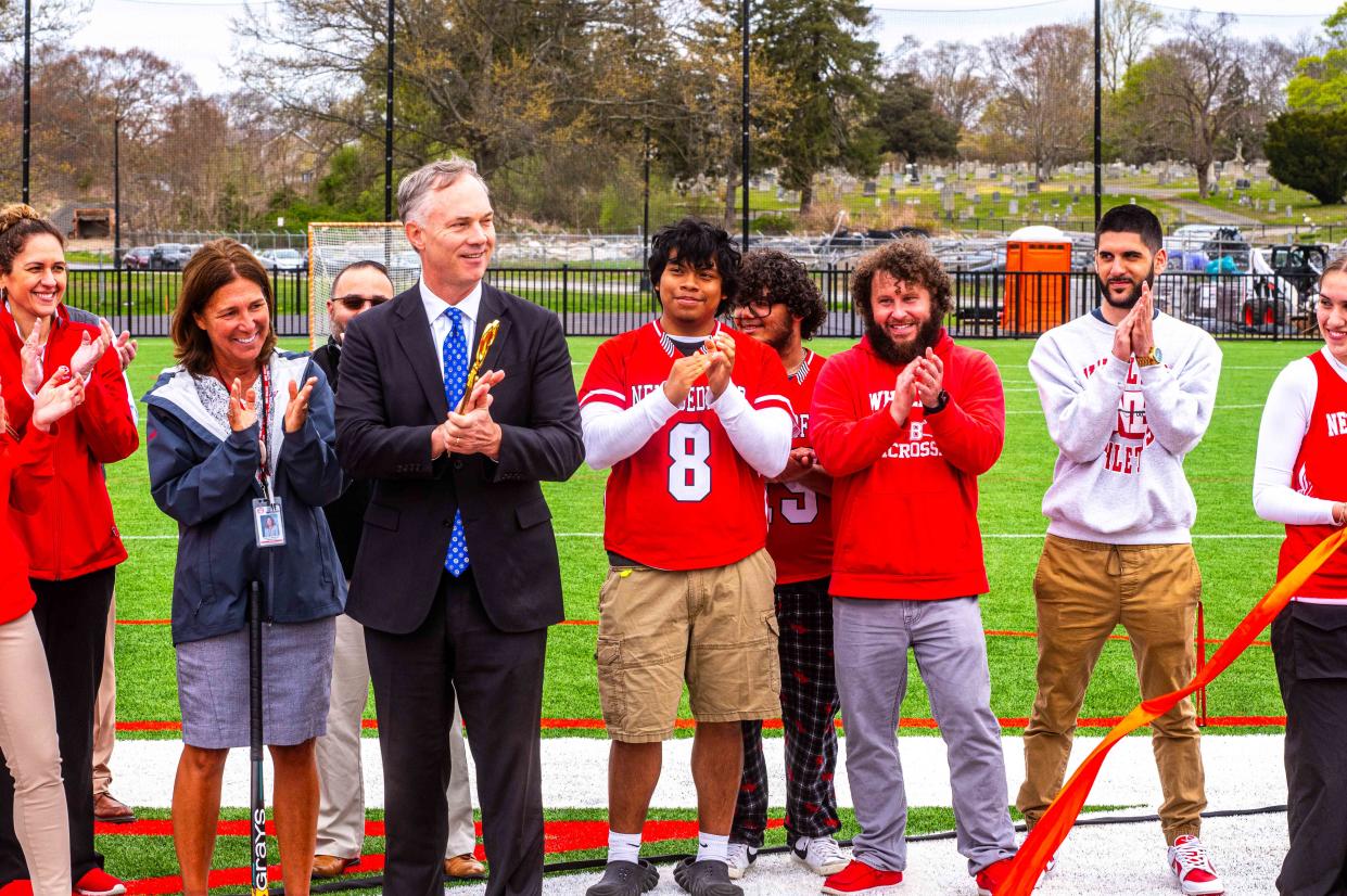New Bedford Mayor Jon Mitchell and others celebrate the Ribbon Cuttin Ceremony on the new turf field at New Bedford High School