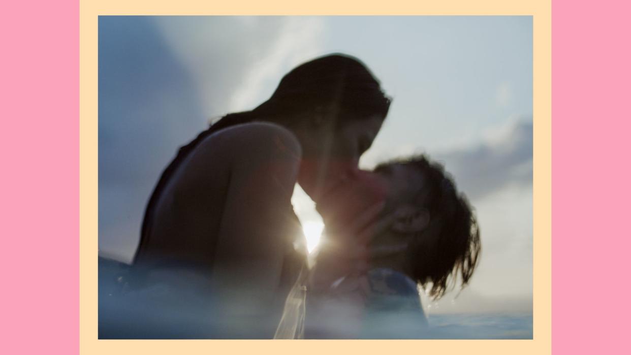  couple in the water kissing as the sun sets 