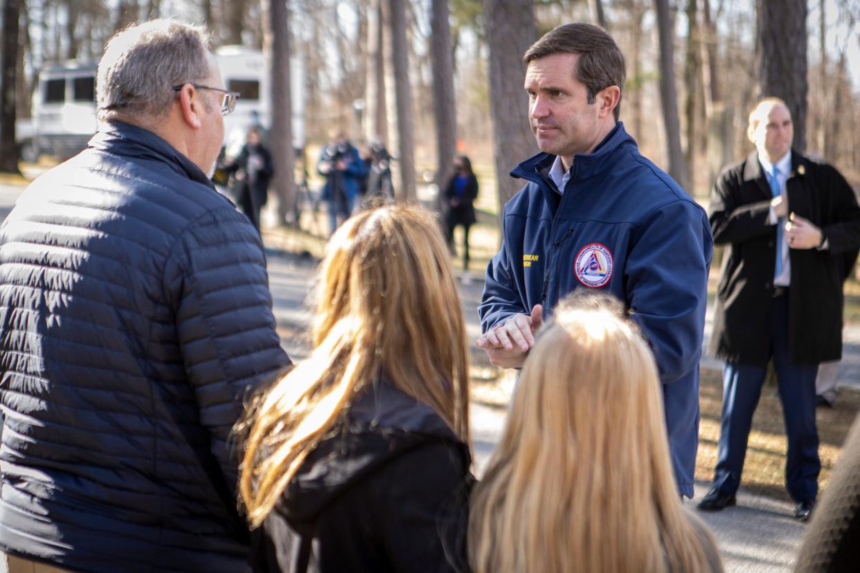 Gov. Andy Beshear talks with residents as he tours pull-behind campers that have been set up in Dawson Springs and Mayfield to provide relief housing for residents displaced by the December 2021 tornado. Jan. 28, 2022