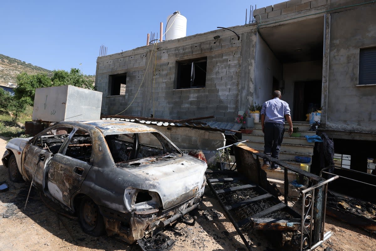 A Palestinian inspects damage to a home in the village of Mughayir in the Israeli-occupied West Bank on Saturday after an attack by Israeli settlers (AFP via Getty)