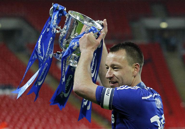 Chelsea's captain, English defender John Terry celebrates with the trophy during the presentation after Chelsea won the League Cup final football match against Tottenham Hotspur in London on March 1, 2015