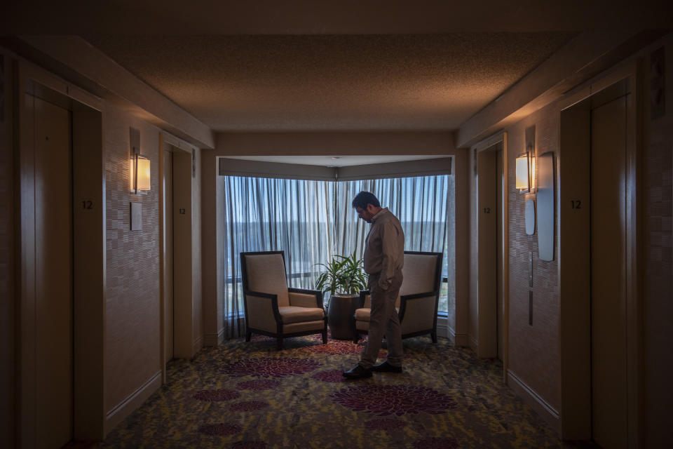 Aaron Eisen, 30, paces back and forth waiting for the remaining attendees to arrive for a gathering for families of Holocaust survivors, at a hotel in East Brunswick, N.J., on Sunday, Sept. 26, 2021. “My grandfather, when he would give speeches, would say that the Holocaust was incomprehensible, that we can’t comprehend how this happened,” Aaron says. “But I think over time we are beginning to comprehend, and what my mother is talking about, is that there’s still so much to learn. With the technology and the archives, there’s still so many more lessons.” (AP Photo/Brittainy Newman)