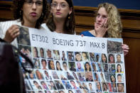 Deveney Williams, right, wipes a tear from her eye as she and Diana Sotomayor, left, and Hayley Freedman, center, all friends of Samya Rose Stumo, hold up a sign depicting those lost in Ethiopian Airlines Flight 302 during a House Committee on Transportation and Infrastructure hearing on the status of the Boeing 737 MAX on Capitol Hill in Washington, Wednesday, June 19, 2019. Stumo was killed in the plane crash. (AP Photo/Andrew Harnik)