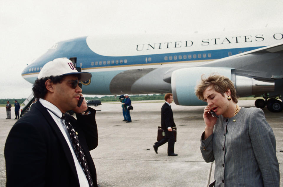 Presidential advisers Steve Rabinowitz and Dee Dee Myers talk on cell phones on the tarmac next to Air Force One, on April 30, 1993.<span class="copyright">Wally McNamee—CORBIS/Getty Images</span>