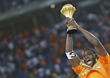 Ivory Coast's captain Yaya Toure raises the trophy after winning the African Nations Cup final soccer match against Ghana in Bata, February 8, 2015. Ivory Coast won the African Nations Cup for the first time in 23 years as they edged Ghana 9-8 on penalties following a goalless draw after extra time in Sunday's final at Estadio de Bata. REUTERS/Amr Abdallah Dalsh