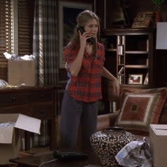 rachel in a red flannel with a blue back and gray sweatpants on friends