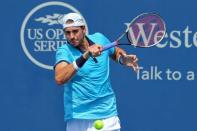 Aug 19, 2017; Mason, OH, USA; John Isner (USA) returns a shot against Grigor Dimitrov (ESP) during the Western and Southern Open at the Lindner Family Tennis Center. Mandatory Credit: Aaron Doster-USA TODAY Sports