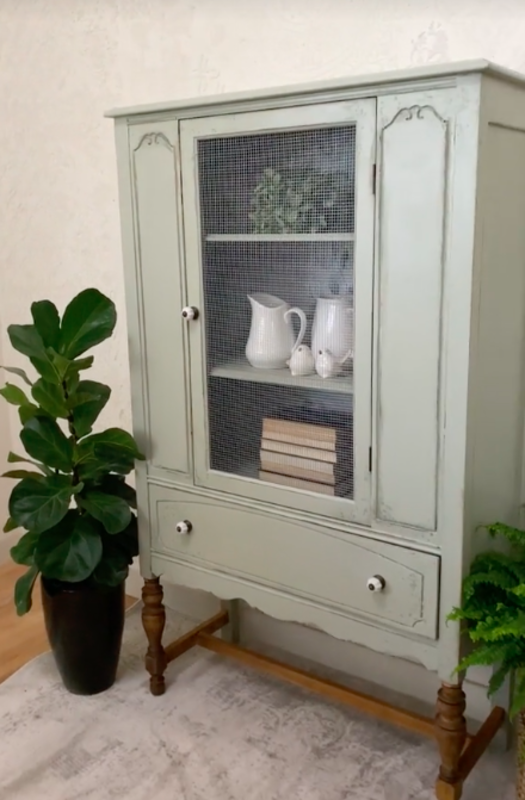 The wood was painted green and the glass was replaced with chicken wire for a farmhouse style update.<p><a href="https://www.tiktok.com/@extremefurnituremakeover/video/7282469102638157062" rel="nofollow noopener" target="_blank" data-ylk="slk:TikTok / @extremefurnituremakeover;elm:context_link;itc:0;sec:content-canvas" class="link ">TikTok / @extremefurnituremakeover</a></p>