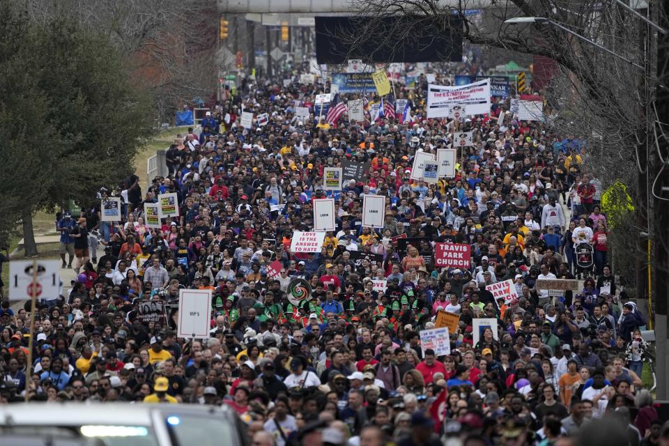 Thousands of walkers take part in a march honoring Martin Luther King Jr. in San Antonio, Monday, Jan. 16, 2023. (AP Photo/Eric Gay)