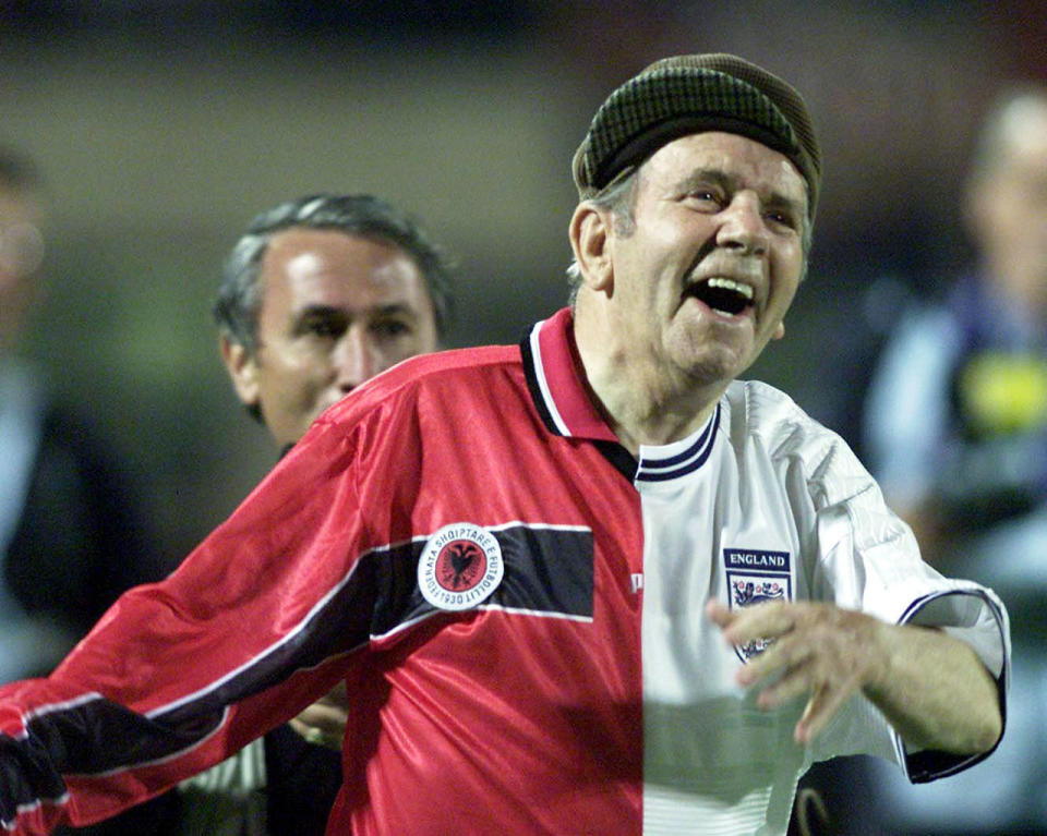 Sir Norman Wisdom entertaining the crowd during half time in the FIFA World Cup qualifier at the Quemal Stafe Stadium, Tirana, Albania. (Tom Hevezi/PA Archive/PA Images)