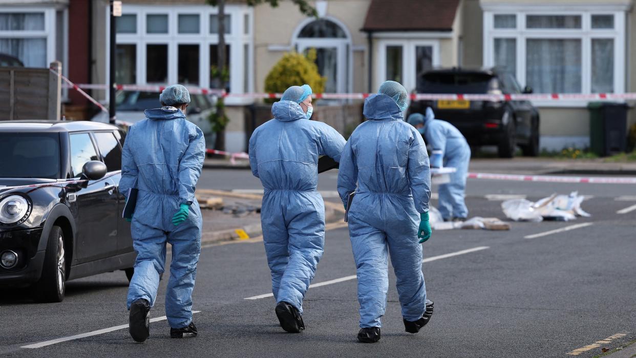  Police forensic officers examining the crime scene in Hainault. 