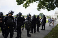 Police in riot gear patrol during a rally near the U.S. Capitol in Washington, Saturday, Sept. 18, 2021. The rally was planned by allies of former President Donald Trump and aimed at supporting the so-called "political prisoners" of the Jan. 6 insurrection at the U.S. Capitol. (AP Photo/Brynn Anderson)