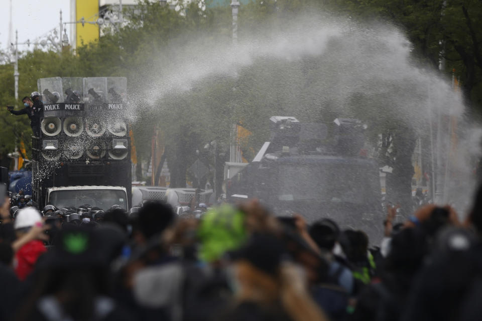 Police use water cannon to disperse protesters as they march to Government House in Bangkok, Thailand Sunday, July 18, 2021. Hundreds of anti-government protesters rallied on Sunday despite the government’s recent measures to prohibit the gathering of more than 5 people in the capital to curb the COVID-19 pandemic. Protesters demanded the resignation of Prime Minister Prayuth Chan-ocha and his cabinet. (AP Photo/Anuthep Cheysakron)