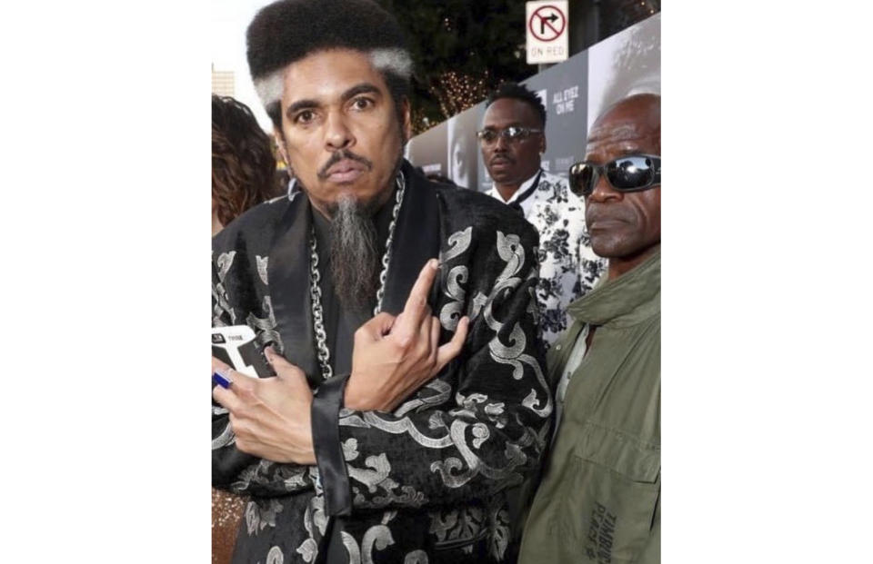 In this photo provided by Nzazi Malonga, Shock G, left, poses at the "All Eyez On Me" film premiere in Los Angeles on June 14, 2017. Shock G, who blended whimsical wordplay with reverence for '70s funk as leader of the off-kilter hip-hop group Digital Underground, has died. He was 57. Nzazi Malonga, a longtime friend who served as head of security and helped manage the group, said the rapper-producer was found unresponsive Thursday, April 22, 2021, in a hotel room in Tampa, Fla. (Nzazi Malonga via AP)