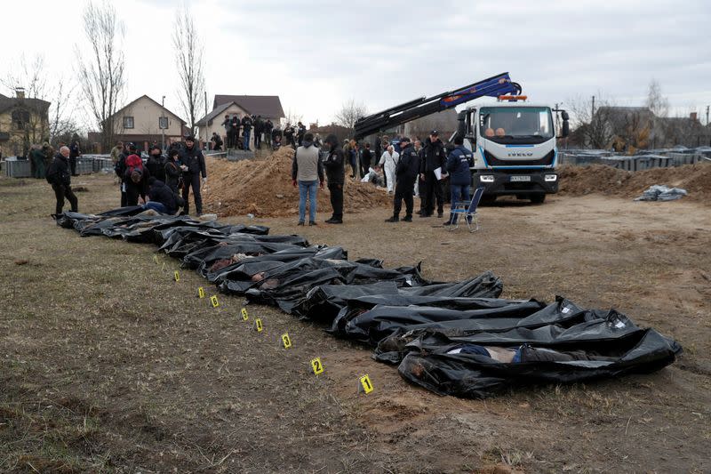 FILE PHOTO: Exhumation of bodies of civilians from a mass grave in Bucha