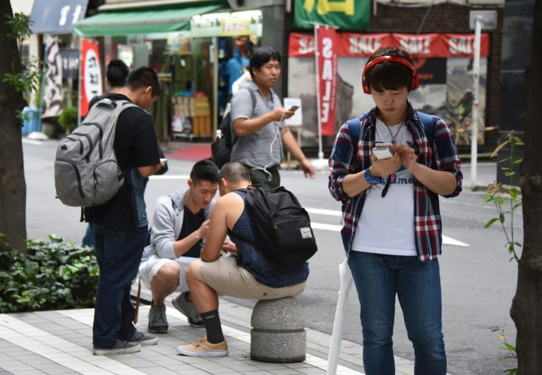 Gamers playing Nintendo's Pokemon Go in Tokyo's Akihabara shopping district on July 22, 2016