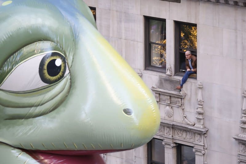 A spectator gets a close up look at the Leo balloon as it passes by on Sixth Avenue during the Macy's Thanksgiving Day Parade 2023 in New York City on Thursday. Photo by John Angelillo/UPI