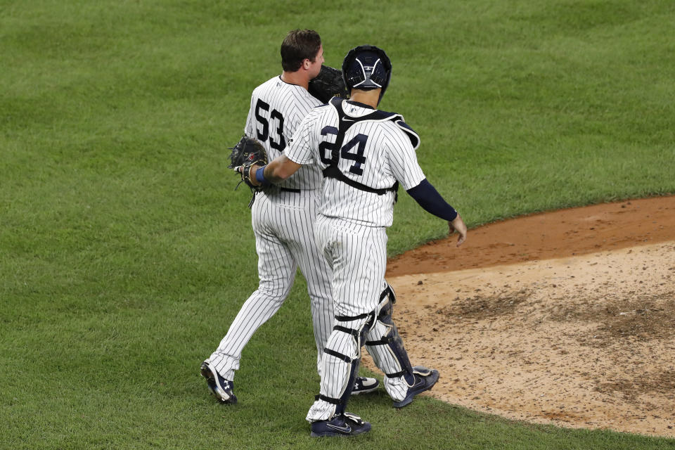 New York Yankees catcher Gary Sanchez (24) talks to relief pitcher Zack Britton (53) after a wild pitch and a passed ball during the ninth inning of the team's baseball game against the Boston Red Sox on Sunday, Aug. 16, 2020, in New York. (AP Photo/Kathy Willens)