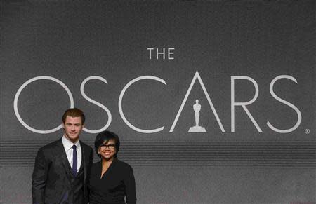 Actor Chris Hemsworth (L) and Academy of Motion Picture Arts and Sciences President Cheryl Boone Isaacs pose for photographers after the 86th Academy Awards nominee announcements in Beverly Hills, California January 16, 2014. REUTERS/Phil McCarten