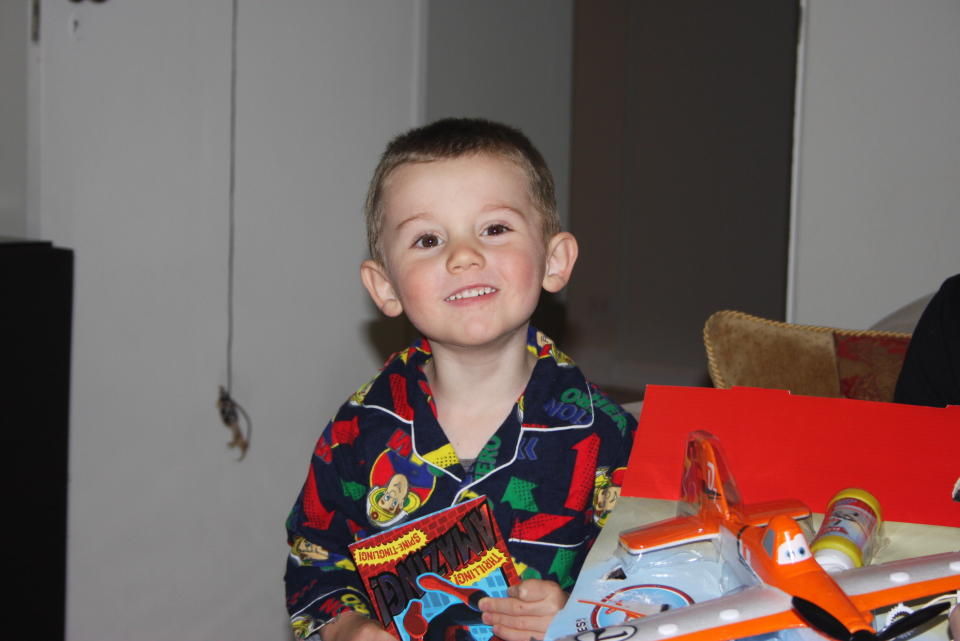 missing three-year-old boy William Tyrrell wearing pyjamas and smiling while unwrapping presents on his birthday