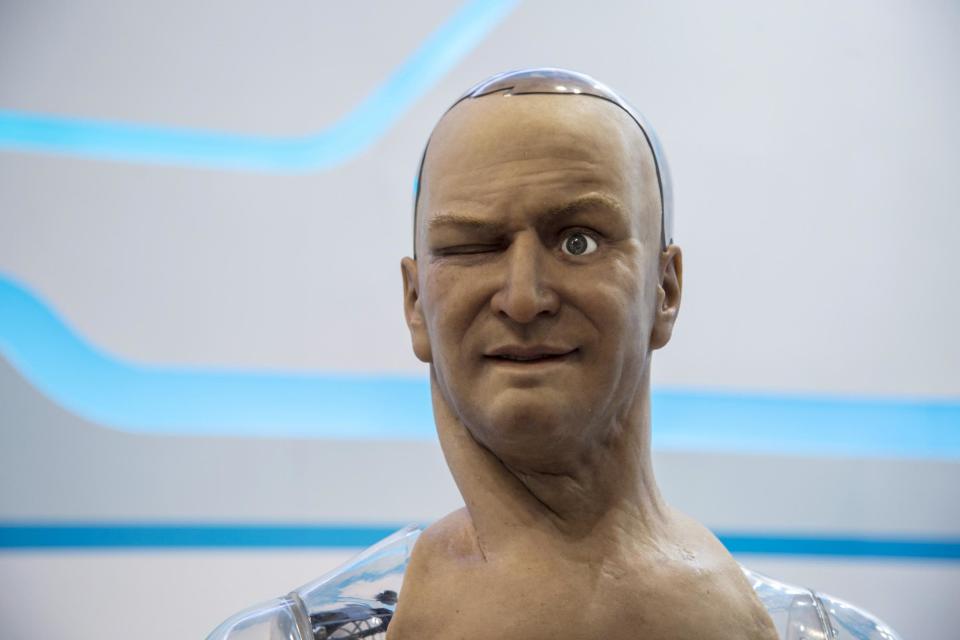 A humanoid robot named Han developed by Hanson Robotics reacts as the controller commands it via a mobile phone to make a facial expression during the Global Sources spring electronics show in Hong Kong April 18, 2015: REUTERS/Tyrone Siu