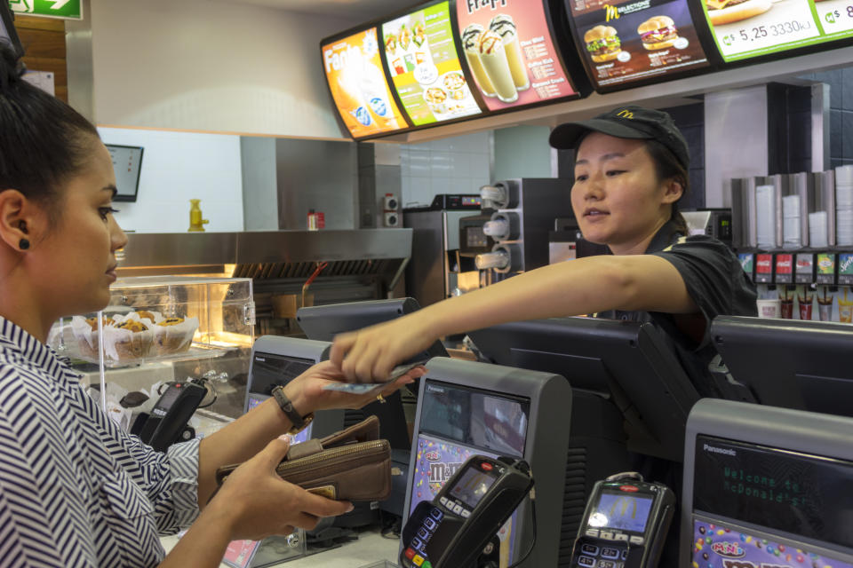McDonald's woman with a job serving a customer.