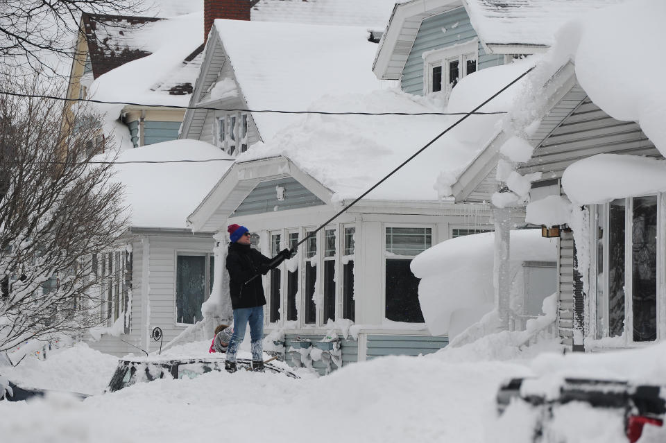  A man attempts to clear his roof of snow on December 26, 2022 in Buffalo, N.Y. / Credit: John Normile / Getty Images