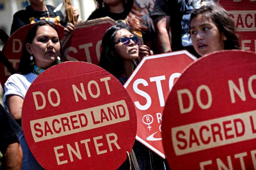 Activists protest on Capitol Hill July 22, 2015 in Washington, DC. Members of the San Carlos Apache Nation and other activists gathered to protest the a section of the National Defense Authorization Act that would turn over parts of Oak Flat that are sacred to the Apache to a foreign copper mining company. AFP PHOTO/BRENDAN SMIALOWSKI (Photo credit should read BRENDAN SMIALOWSKI/AFP via Getty Images)