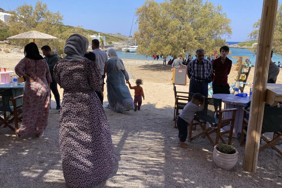 Migrants gather on a beach after their arrival on the southern island of Kythera, Greece, on Thursday, Aug. 18, 2022. Greek authorities say another sailboat with about 70 migrants on board has arrived on Kythera, the third in just under two days to reach the southern island that is not a usual destination for asylum-seekers trying to reach the European Union. (Ippolytos Prekas/kythera.news via AP)